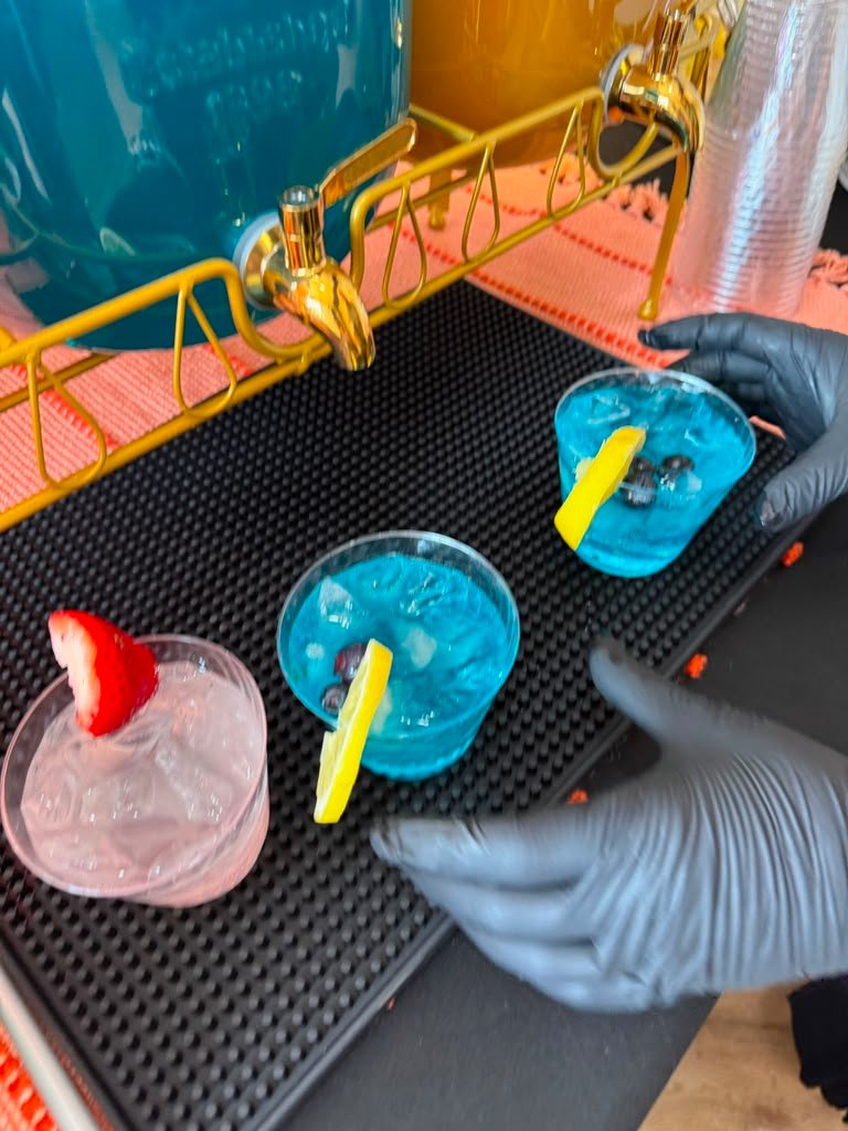Pouring a signature mocktail with fruit garnish